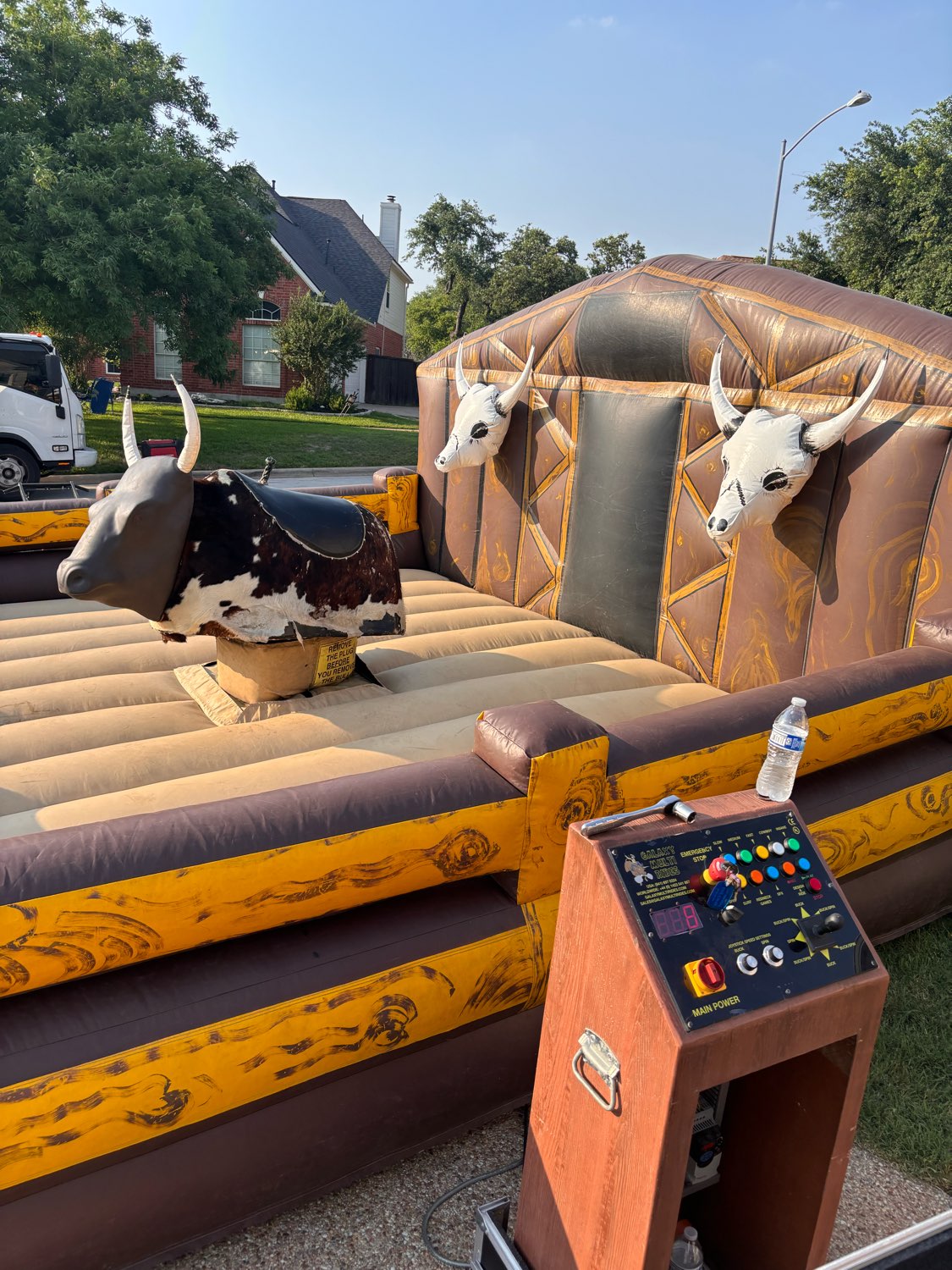 A mechanical bull ride with an inflatable arena and operator control panel